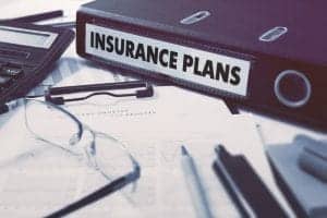  Insurance Plans on Ring Binder. Blured, Toned Image